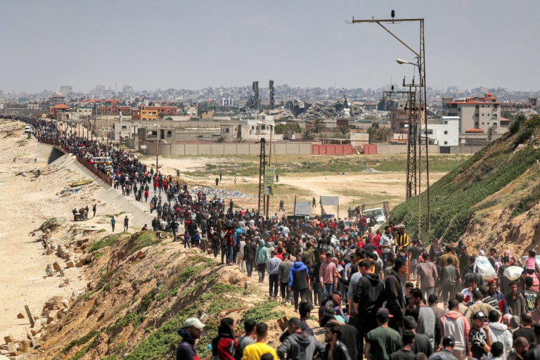 Displaced Palestinians take a coastal road through central Gaza, hoping to return to the territory