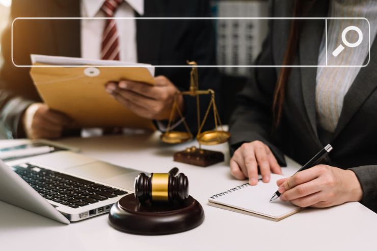 Two lawyers sitting at a desk discussing their SEO strategy