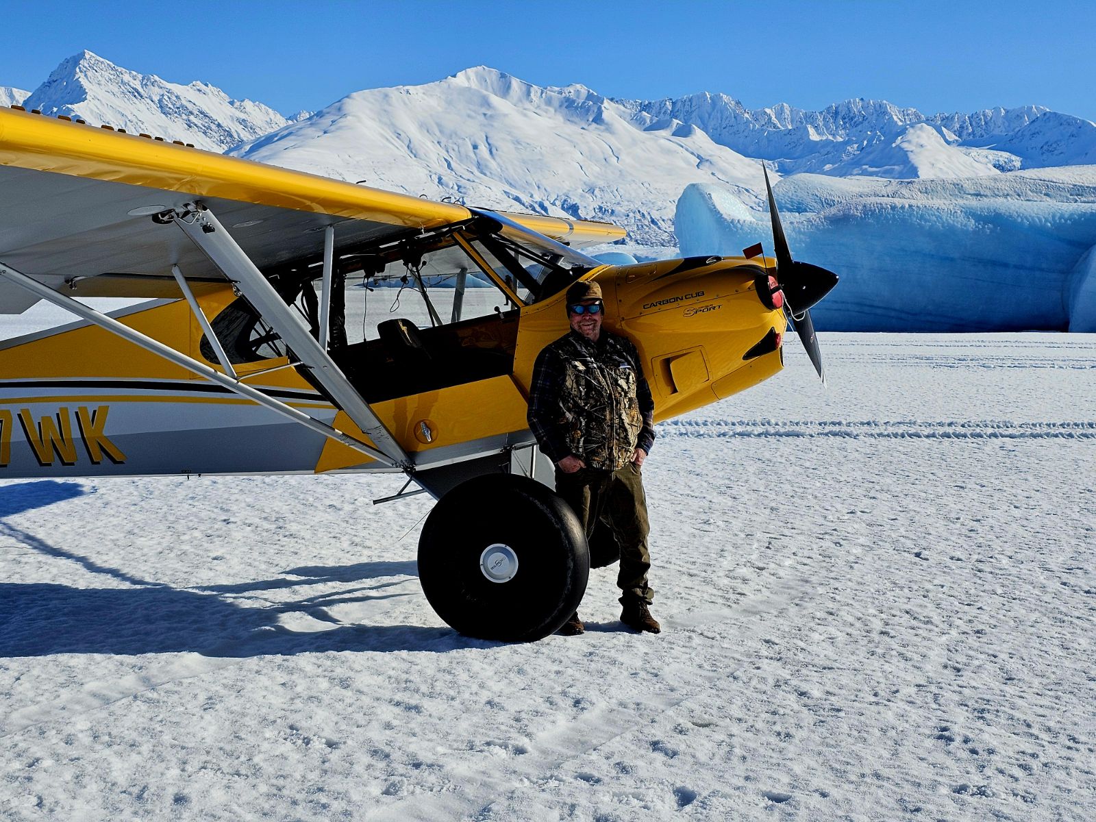 Scott Ogan on a glacier landing with a plane, Alaska, USA.