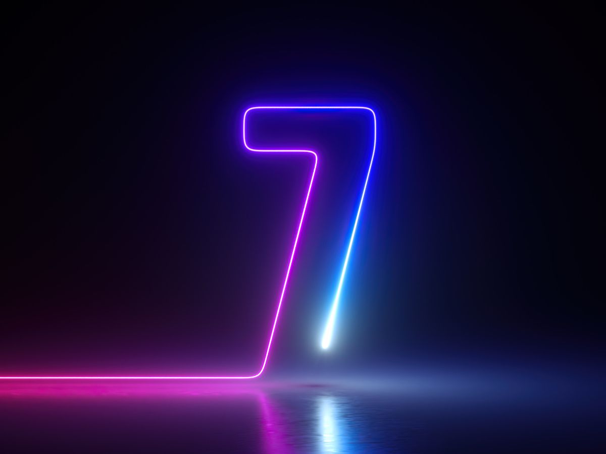 A 3D render of a neon number seven outline glowing in the dark.