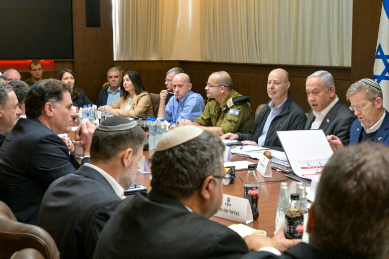 An Israeli Government Press Office picture shows Prime Minister Benjamin Netanyahu (2-R), heading the security cabinet meeting that endorsed the ceasefire deal