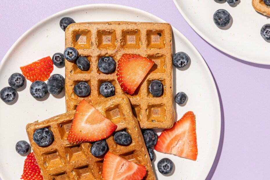 waffles with berries on white plates