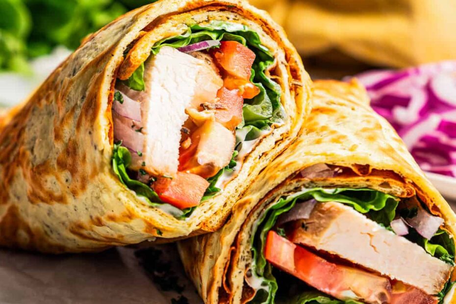 Two halves of cottage cheese flatbread wrap arranged on a piece of parchment paper.