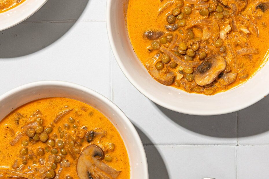 mushroom and lentil stew in white bowls with spoons