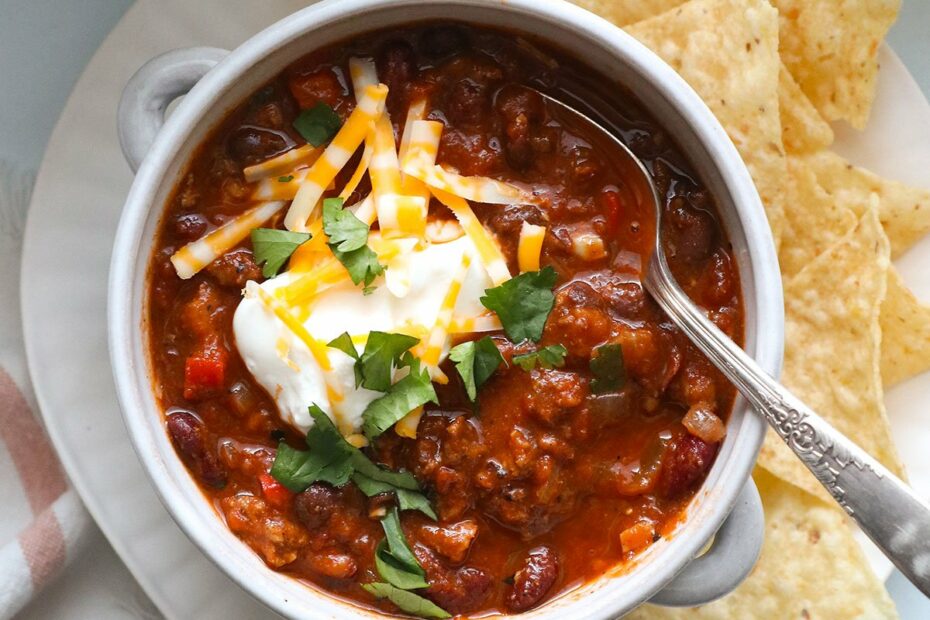 turkey chili topped with greek yogurt, cheese, and cilantro.