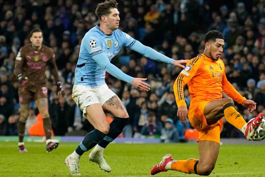 Real Madrid's Jude Bellingham, right, scores his sides third goal during the Champions League playoff first leg soccer match between Manchester City and Real Madrid at the Etihad Stadium in Manchester, England, Tuesday, Feb. 11, 2025. (AP Photo/Dave Thompson)