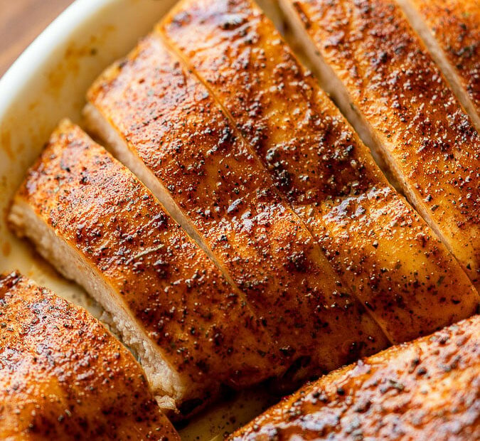 Sliced chicken breast in a rimmed dish.