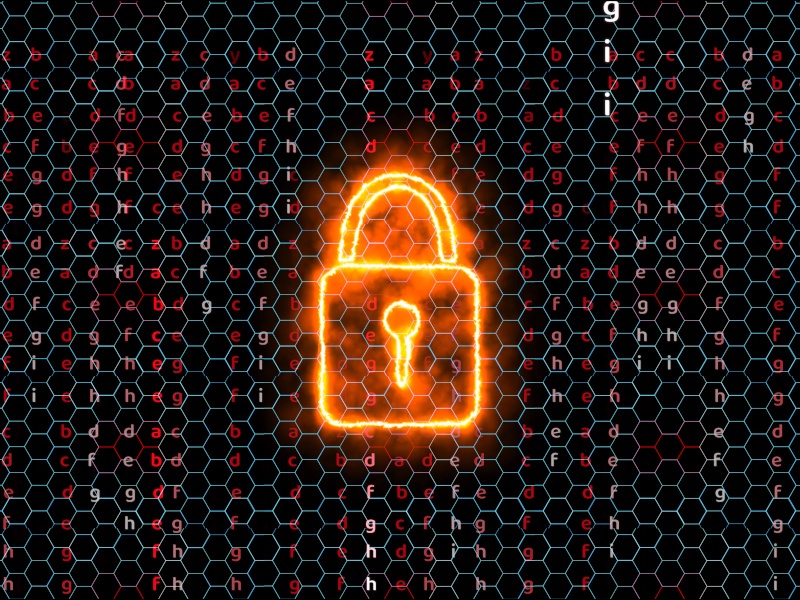 A digital image of a burning lock situated in between hexagons and code.