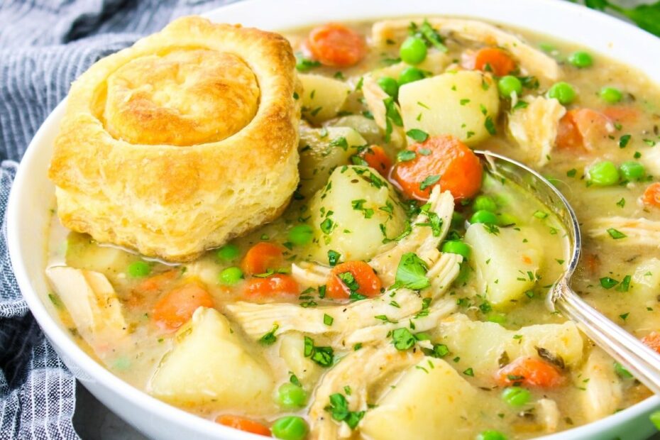 Creamy Chicken Pot Pie soup in a bowl with a baked puff pastry shell on top.