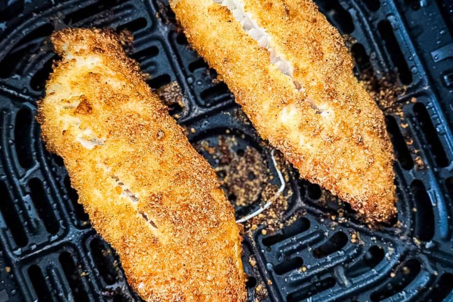 Crispy air fryer parmesan tilapia fillets in the air fryer basket.
