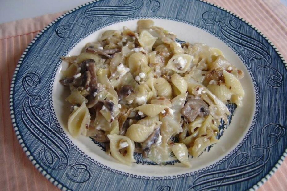 Caramelized cabbage and mushroom pasta with cottage cheese on plate
