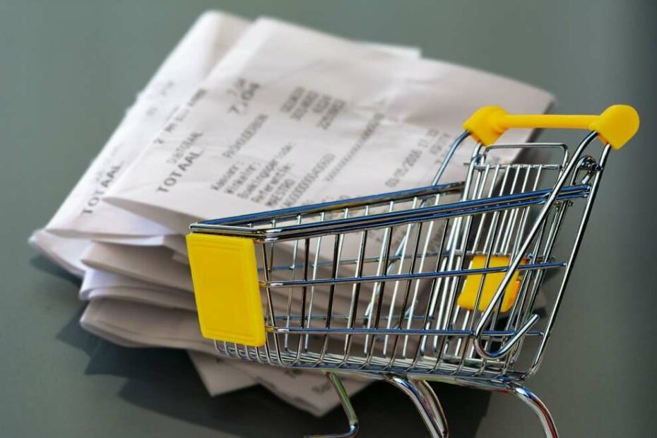 Shopping receipts and supermarket cart for frugal living tips and tricks to make ends meet