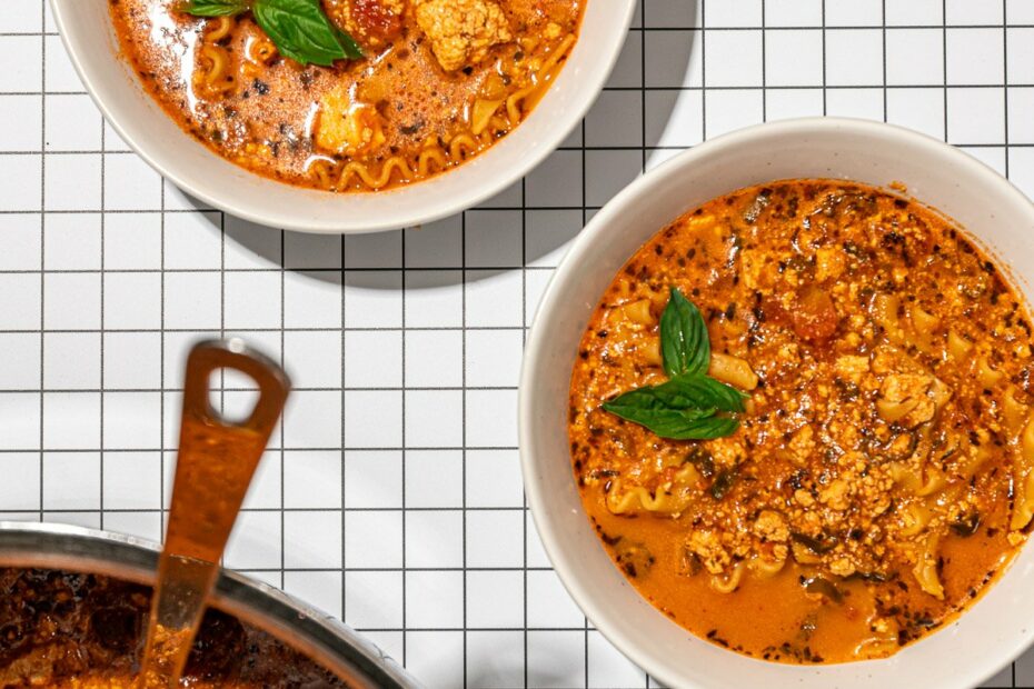 bowls of lasagna soup with pot and ladle