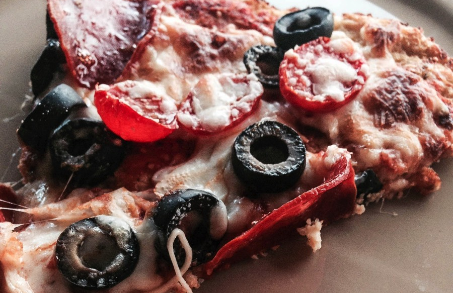 An image of bariatric pizza with cheese, olives, and pepperoni on a cauliflower crust to help illustrate pizza after bariatric surgery.