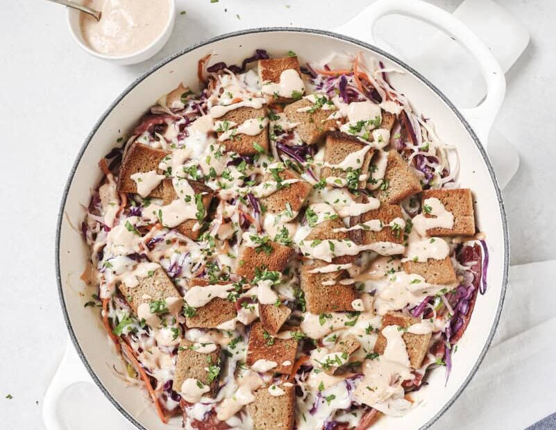 reuben casserole in a white dish with dressing