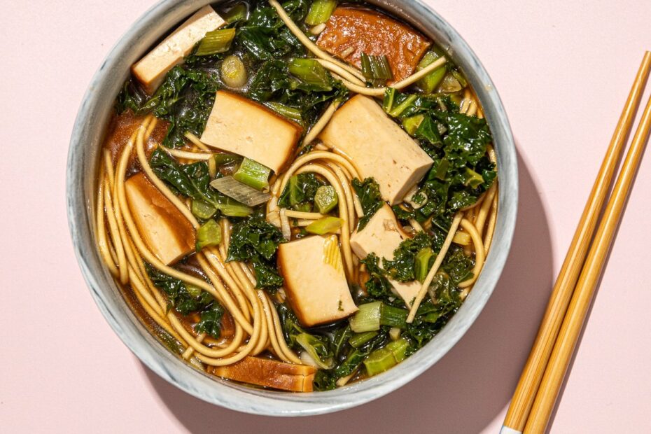 vegan ramen with kale and tofu in bowl with wooden chopsticks