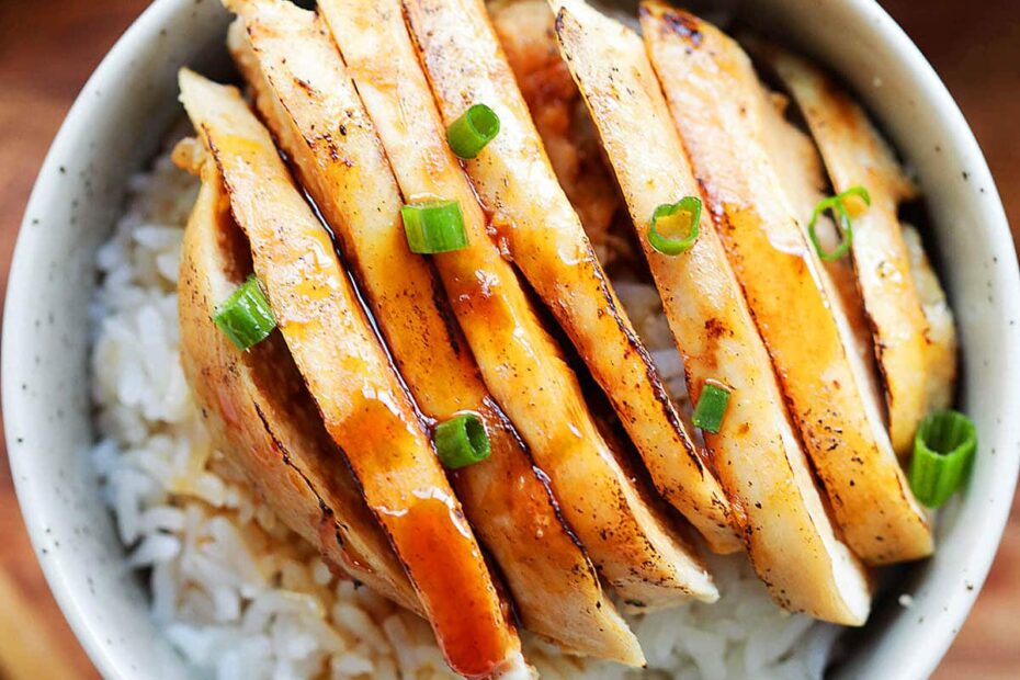 Juicy chicken in a tangy Mandarin sauce, garnished with scallions and served with rice.