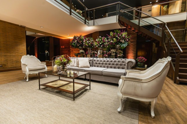 Safe reception area with comfortable seating and elegant floral arrangements.
