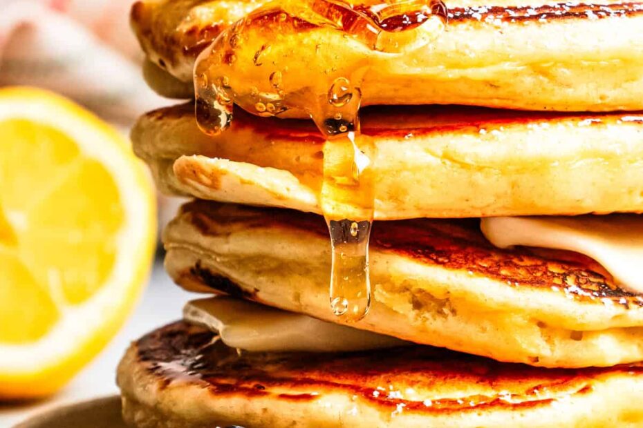 Syrup dripping down a stack of pancakes.