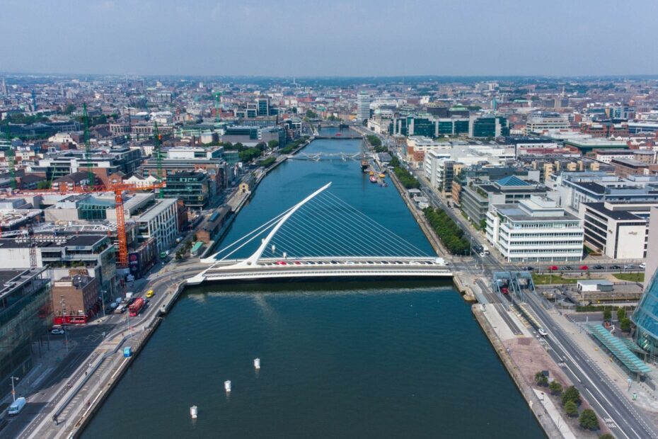 An aerial shot of the Samuel Beckett bridge over the River Liffey in Dublin on a bright, clear day.