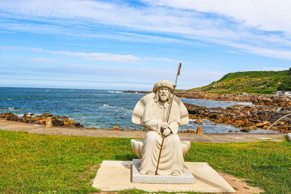 A stone sculpture of pilgrim on the coastal route of the Camino