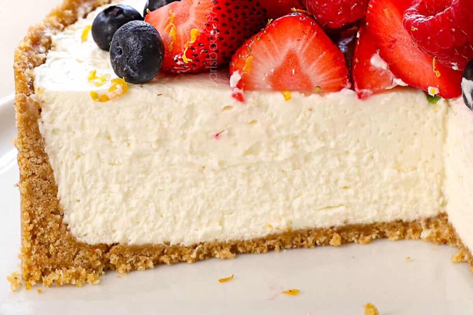 easy no bake cheesecake on a platter with slices missing showing the thick Graham cracker crust