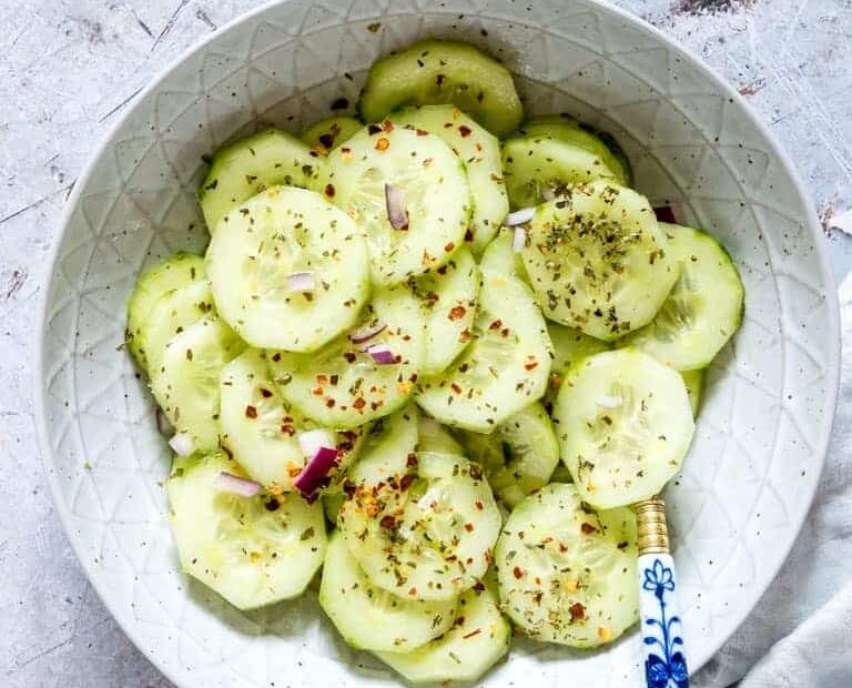 cucumber salad recipe in a bowl with a spoon