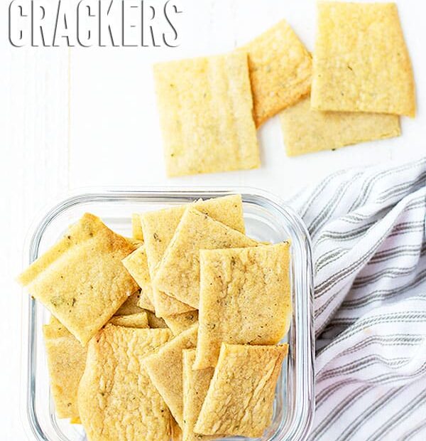 Batch of sourdough crackers in a glass container. Text overlay reads, "Sourdough Discard Crackers".