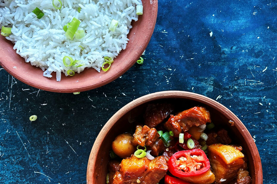 Thit Kho tao in a serving bowl next to a bowl of rice.