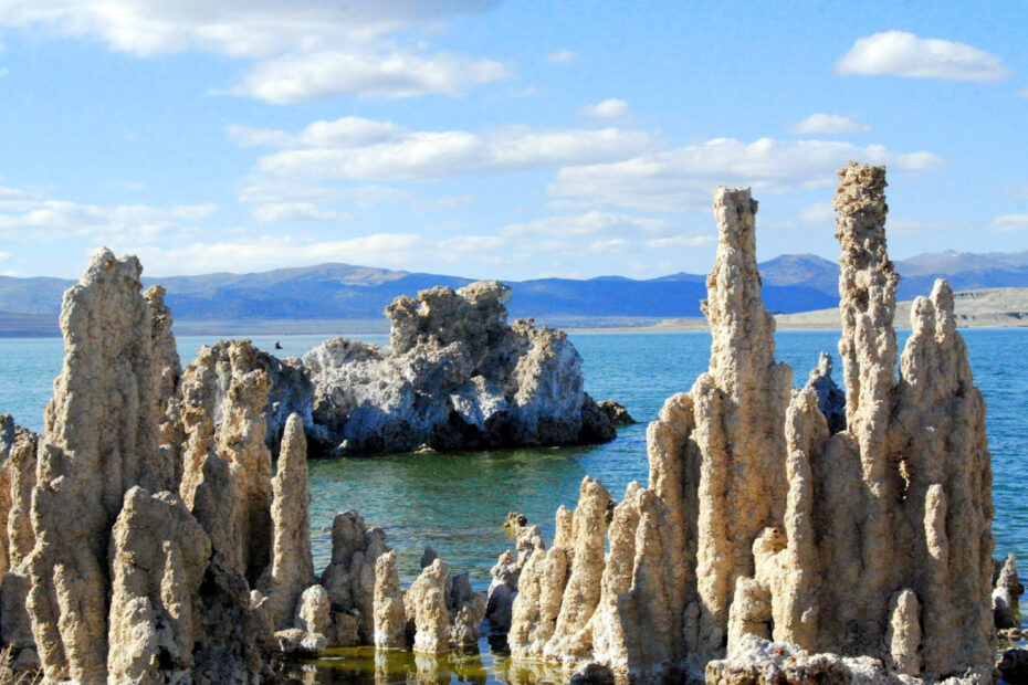 A series of rock formations stand on the edge of Lake Mono