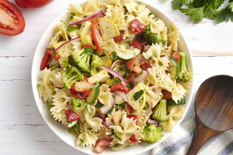 Overhead view of a bowl of summer vegetable pasta salad.