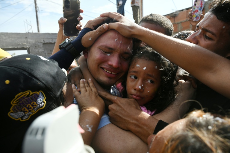 Mervin Yamarte (C), a Venezuelan migrant repatriated from a prison in El Salvador, is welcomed by his family upon arrival at his home in Maracaibo, Venezuela