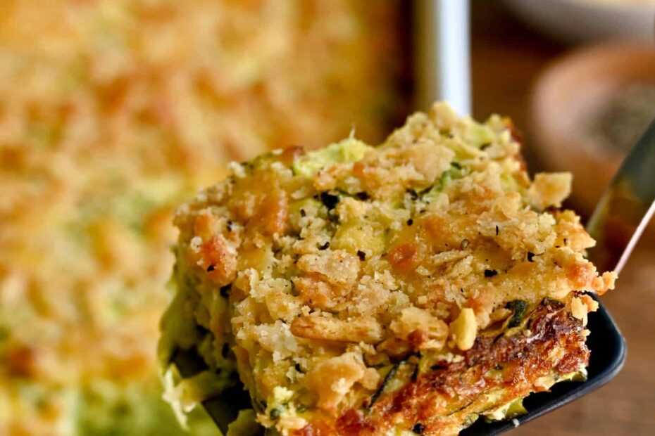 A slice of cheesy zucchini casserole on a spatula.