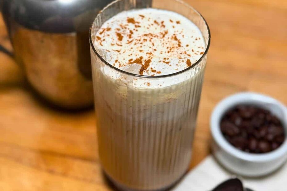 A glass with coffee and cold foam on top