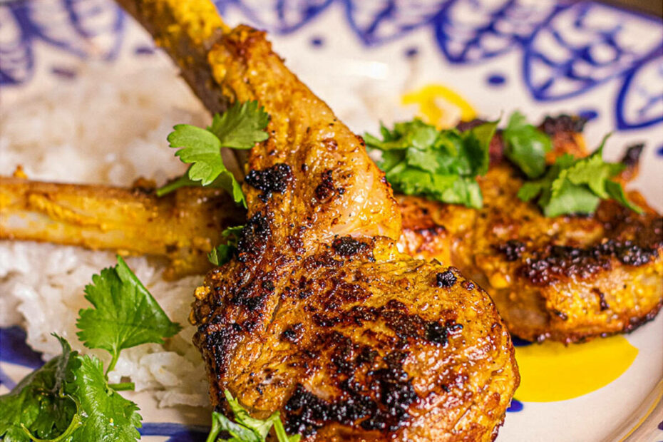 Lamb chops topped with cilantro on top of rice