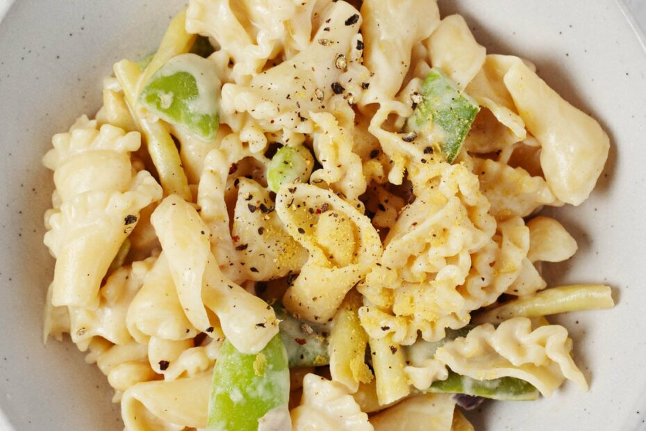 A roasted garlic tahini sauce has been used to make a light, creamy vegan pasta. It