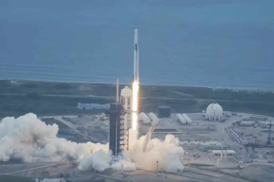 A rocket seen shooting upward with a coastline in the background.