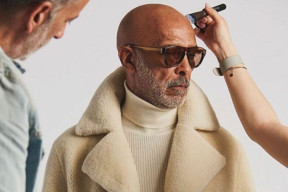 feature image for an article on style for men over fifty, close-up image of an older male model getting touched up at a photo shoot