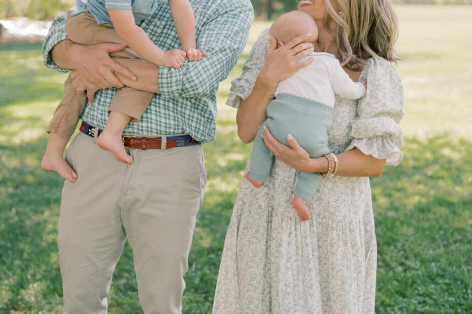 Woman taking family pictures with husband and sons