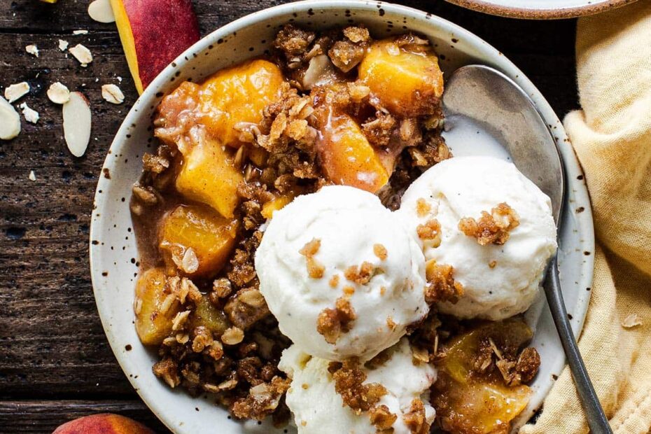 bowl of gluten free peach crisp and ice cream