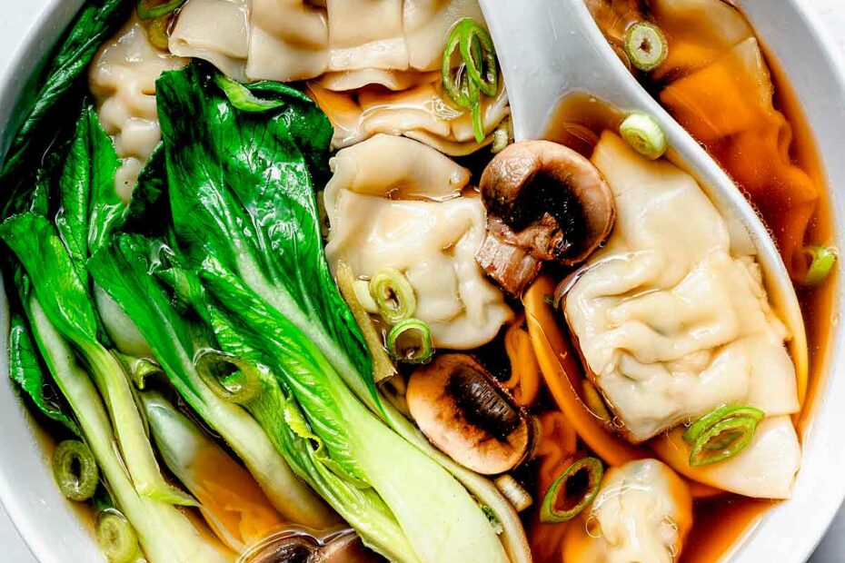 Wonton Soup with mushrooms and bok choy in bowl with spoon