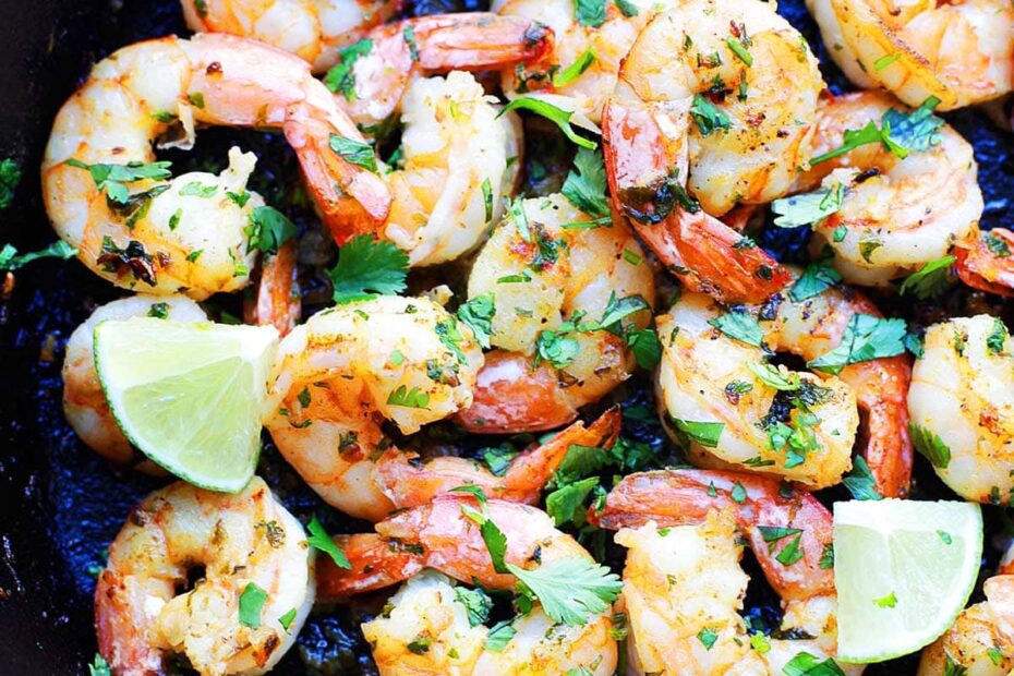 Cilantro lime shrimp recipe cooked in a cast-iron skillet with garlic, butter, and fresh lime.