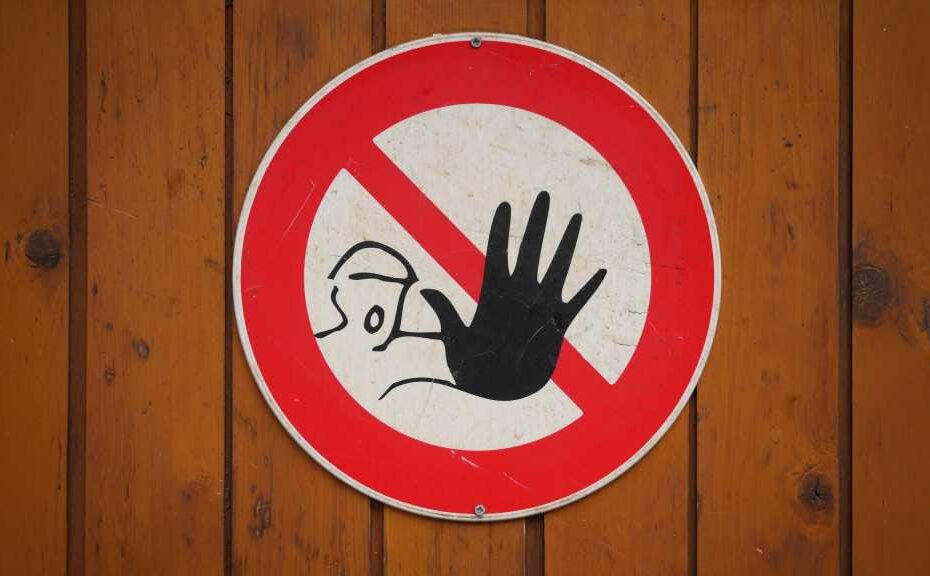 sign with person with hand outstretched meaning stop