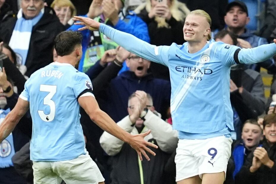 Erling Haaland celebrates his second goal with Ruben Dias