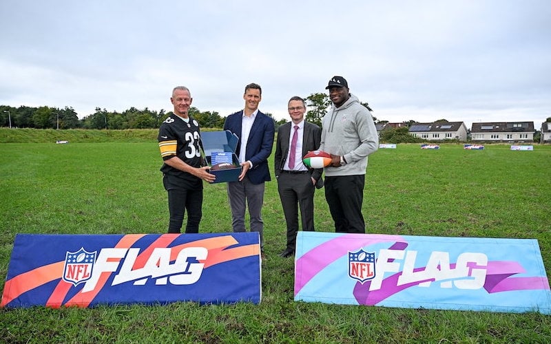 September 4, 2025:Minister for Arts, Media, Communications, Culture and Sport Patrick O'Donovan TD with Henry Hodgson, General Manager NFL UK and Ireland, Pittsburgh Steelers’ legend Merril Hoge, left, and NFL player Efe Obada at Kingswood Community College in Dublin to announce the NFL Flag Kickoff initiative in post-primary secondary schools in Ireland.