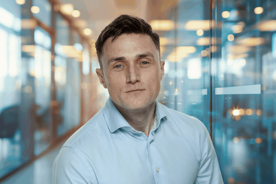A portrait of Rob Brown in a light blue shirt against a blurred office background.