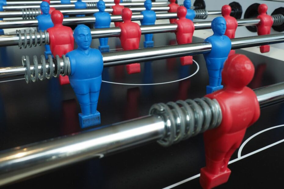 A football table with blue and red figurines.