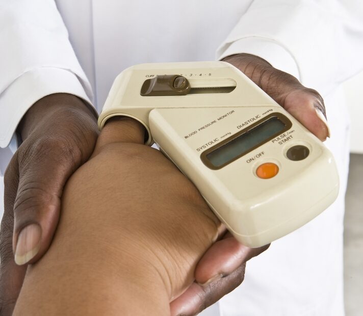 Doctor checks blood pressure for patient to help illustrate what are the requirements for gastric bypass surgery