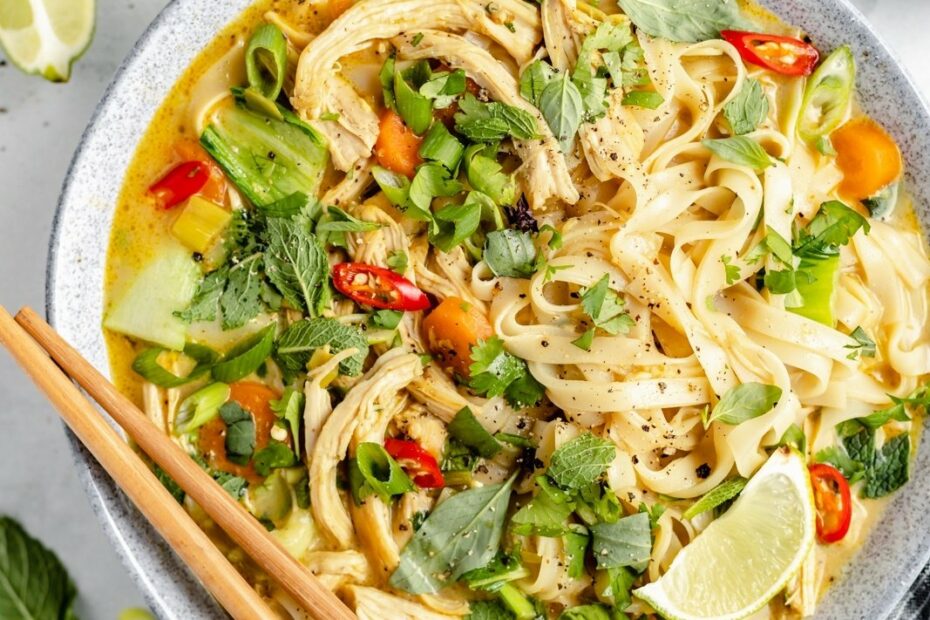 curry chicken noodle soup in a bowl with chopsticks
