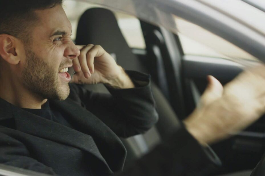 Angry man on phone in a car